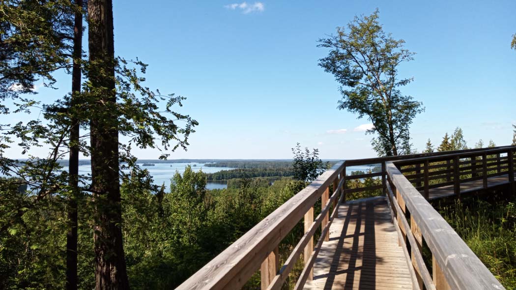 A wooden bridge leads to the viewpoint.